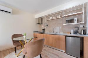 a kitchen with a table and chairs in a room at Aima Apartments in Lekki +1 photo
