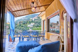 a balcony with a table and chairs and a view at The Dreamer's Terrace in Vico Equense