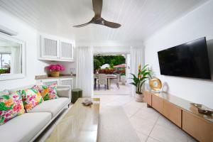 a living room with a couch and a flat screen tv at Glitter Bay Apartment 104 in Saint James