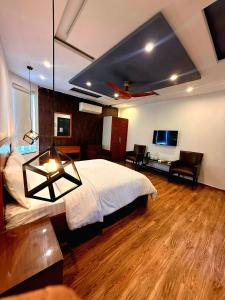 a bedroom with a bed and a desk and a tv at 12th Avenue in Lahore