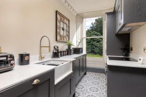 a kitchen with a sink and a large window at The Victorian Suite in Marske