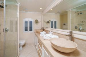 a bathroom with a sink and a shower and a toilet at Glitter Bay Apartment 104 in Saint James +3 photos