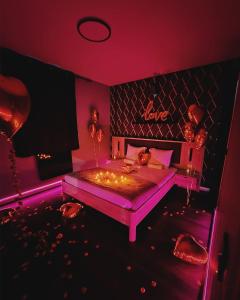 a bedroom with a bed with a purple lighting at Maison du Château d'eau Proche Disney, Parc Astérix, CDG, Paris, Parc des exposition in Mitry-Mory +17 photos