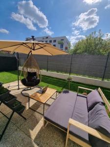 a patio with a hammock and a swing and an umbrella at Garden Residence in Nitra