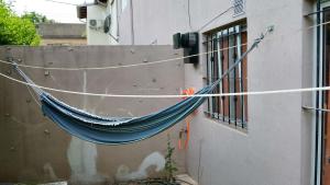 a hammock tied to the side of a building at Tu hogar en Concordia in Concordia +3 photos