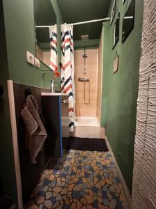 a bathroom with a shower and a toilet and a sink at Le Jasmin in Lure