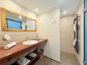 a bathroom with a sink and a mirror at Boutique Hotel Zuckerfabrik Stuttgart in Stuttgart