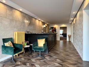 a hallway with chairs and a table in a building at Boutique Hotel Zuckerfabrik Stuttgart in Stuttgart