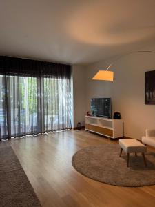 a living room with a couch and a table at Tróia Oasis Villa in Troia