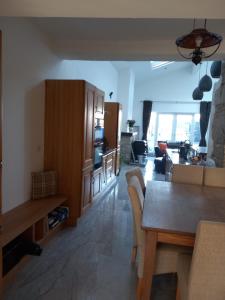 a kitchen and living room with a table and chairs at Teach Sile in Kiltimagh