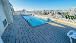 a swimming pool on a balcony of a building at Viabo in Viña del Mar