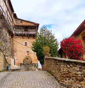 a cobblestone street in front of a building at Don Divino in Medina de Pomar