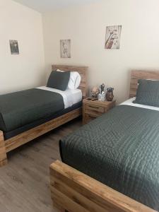 a bedroom with two beds and two night stands at Walking Distance to Stagecoach in Indio +19 photos