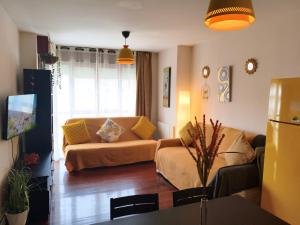a living room with a couch and a table at Don Divino in Medina de Pomar