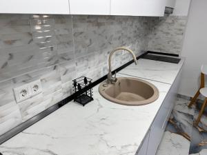 a bathroom with a sink and marble counter top at Arius King in Satu Mare