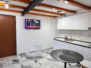 a kitchen with a table and a counter top at Arius King in Satu Mare