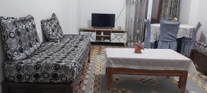 a living room with a couch and a table at Appartcirta in Constantine +2 photos