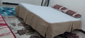 a bed that is covered in brown paper at Appartcirta in Constantine