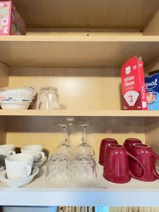 a shelf with wine glasses and other items on it at New York Flushing private room in Flushing +5 photos