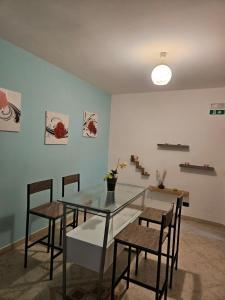 a dining room with a glass table and chairs at Due Passi dal Gate in Salerno Airport - Aeroporto di Salerno