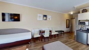 a bedroom with a bed and a dining room at Penzión Mika in Štúrovo