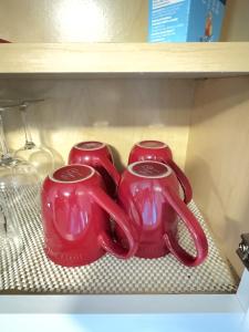 two red vases are sitting on a shelf at New York Flushing private room in Flushing
