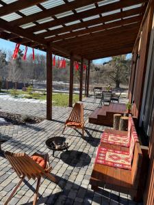 a patio with two chairs and a fire pit at Porichka Home in Roslavichi