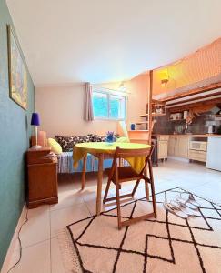 a room with a table and a kitchen with a bed at Studio Piscine en Drôme Provençale Repas Asiatique sur demande in Taulignan