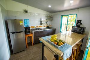 a kitchen with a counter with a bowl of fruit on it at Finca La Molienda, espléndido Mirador del Quindio in Circasia +9 photos