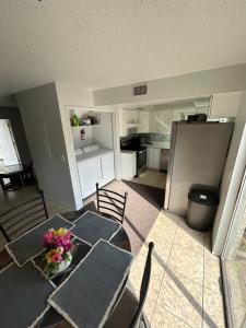 a room with a table and chairs and a kitchen at Plum Cozy Spot in Seffner