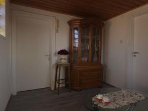 a room with a wooden hutch and a glass table at Ferienwohnung Sonne in Bad Staffelstein +2 photos