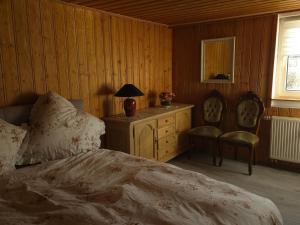 a bedroom with a bed and a table and chairs at Ferienwohnung Sonne in Bad Staffelstein