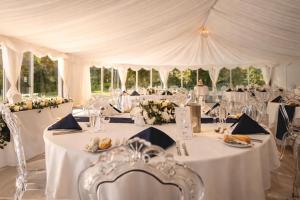 a wedding tent with tables with white tablecloths at Friars Carse Country House Hotel in Dumfries