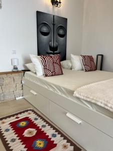 a bedroom with a bed with a face on the wall at Largo de Santa Ana in Cadaval