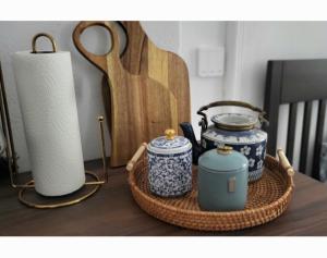 a wicker basket with two blue and white vases and a candle at Niebo in Lublin