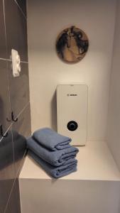 a pile of towels sitting on a counter in a bathroom at Niebo in Lublin +5 photos