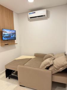 a room with a bed and a air conditioner on the wall at Paraná Beach Apart Hotel in Encarnación
