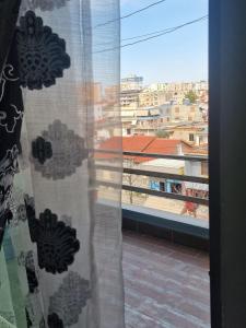 a window with a view of a city at Elegant Apartment City Center in Fier