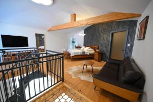 a living room with a couch and a tv at Villa OLIVA in Kľačany