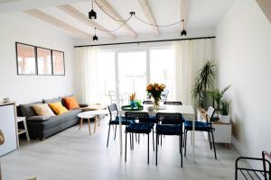 a living room with a table and chairs and a couch at 4 Pory Roku in Darłowo