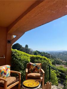 two chairs and a table on a patio with a view at Côte d azur Magnifique studio in Les Issambres