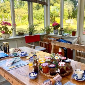 a wooden table with food on it in a room with windows at Stroud House in Freshwater
