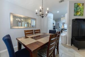 a dining room with a table and chairs and a bathroom at Modern Updates - Great Location - King Bed- BMT in San Antonio
