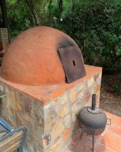 a brick oven sitting on top of a brick wall at Casitas del bosque in San Bernardino
