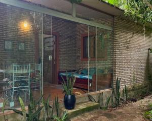 a screened in patio with a table and a chair at Casitas del bosque in San Bernardino