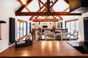 a dining room and living room with a dining table at Rivington Barn in Kerne Bridge