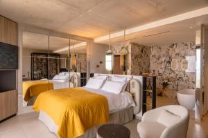 a bedroom with a large bed with a yellow blanket at Villa Urbana in Porticcio +151 photos