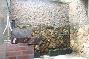 a stone wall with a sink in front of it at Villa Intan 2 in Amed