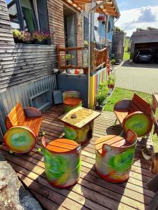 a patio with a table and chairs on a deck at Etappe 17 - am Kylltal Radweg in Birgel