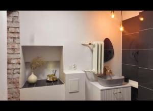 a bathroom with a sink and a mirror and a sink at Sztukmistrz Magician Art Rooms in Lublin +63 photos
